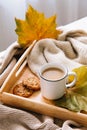 Autumn and winter home still life: a cup of coffee, cookies and yellow leaves. Seasonal breakfast, morning coffee.