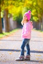 Autumn winter kid girl blond with jeans and pink snow cap