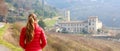 Autumn winter landscape with young woman looking the Astino Valley with the Abbey Former Monastery of Astino Bergamo, Italy.