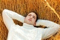 Autumn winter man portrait laying in golden grass Royalty Free Stock Photo