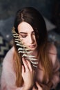 Autumn, Winter portrait: Young sad woman dressed in a warm woolen cardigan posing inside. Royalty Free Stock Photo