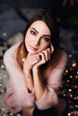 Autumn, Winter portrait: Young sad woman dressed in a warm woolen cardigan posing inside. Royalty Free Stock Photo
