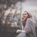 Autumn/winter portrait: young woman dressed in a warm woolen cardigan Royalty Free Stock Photo
