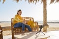 Autumn winter season in tropical seaside resort. Middle-aged woman recording video on smartphone Royalty Free Stock Photo