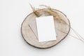 Autumn, winter stationery still life. Blank greeting card, invitation mockup on cut wooden round board. Craft envelope