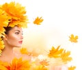 Autumn woman. Beauty model girl with autumn bright leaves hairstyle Royalty Free Stock Photo