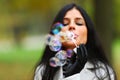 Autumn woman blow bubbles