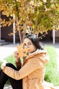 Autumn woman. Fall season concept. A portrait of pretty female with an yellow autumn leaf