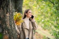 Autumn woman with fall yellow maple leaf, outdoor portrait. Beautiful model with autumn leaves, fall yellow maple in Royalty Free Stock Photo