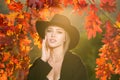 Autumn woman with fall yellow maple leaf, outdoor portrait. Beautiful model with autumn leaves, fall yellow maple in Royalty Free Stock Photo
