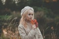 Autumn woman with red fall maple leaf on nature background Royalty Free Stock Photo
