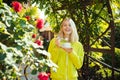 Autumn woman in sweater with cup of coffee smiling and enjoying sunshine. Happy smiling girl holding hot drink in her Royalty Free Stock Photo