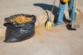 Autumn work in the park. Cleaning of fallen leaves.Cleaners clean the street from the fallen leaves in the fall and spring Royalty Free Stock Photo