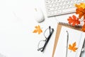 Autumn workspace. Laptop, notebook and fallen leaves. Royalty Free Stock Photo