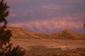 Sunrise clouds of pink and white over the hills