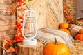 Autumn yellow leaves, pumpkins, autumn, barrel, lamp, straw, wooden door on the background.