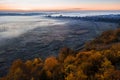 Autumn yellow trees and blur fog in the valley. Sunrise cold morning mood. Aerial drone photo landscape.