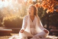 Autumn Yoga Serenity. Young Woman Engaging in Outdoor Relaxation, Embracing the Tranquil Energy of the Season
