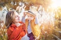 Autumn. Young mother and baby boy (child, kid) having fun outdoors on the fall city park. Royalty Free Stock Photo