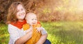 Autumn. Young mother and little baby boy (child, kid) having fun outdoors on the fall city park. Royalty Free Stock Photo