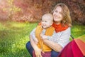 Autumn. Young mother and little baby boy (child, kid) having fun outdoors on the fall park. Royalty Free Stock Photo