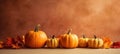 Autumnal charm with pumpkins and leaves on a beige table a cozy and festive Thanksgiving or Halloween setting Royalty Free Stock Photo