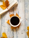 Autumnal composition with coffee and yellow leaves