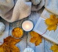 Autumnal composition with candle and yellow leaves