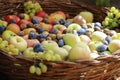 Autumnal concept with a sack full of fresh apples and grapes, outdoor shot Royalty Free Stock Photo