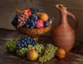 Autumnal fruit still life with Georgian jug on rustic wooden tab Royalty Free Stock Photo