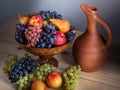 Autumnal fruit still life with Georgian jug on rustic wooden tab Royalty Free Stock Photo