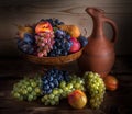 Autumnal fruit still life with Georgian jug on rustic wooden tab Royalty Free Stock Photo