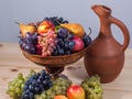 Autumnal fruit still life with Georgian jug on rustic wooden tab Royalty Free Stock Photo