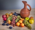 Autumnal fruit still life with Georgian jug on rustic wooden tab Royalty Free Stock Photo