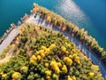 Autumnal landscape view of a mountain road and a lake Royalty Free Stock Photo