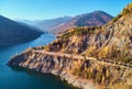 Autumnal landscape view of a mountain lake and a road Royalty Free Stock Photo