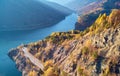 Autumnal landscape view of a mountain lake and a road Royalty Free Stock Photo