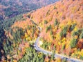 Autumnal landscape view of a mountain road and a car passing by Royalty Free Stock Photo
