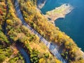 Autumnal landscape view of a mountain road and a lake Royalty Free Stock Photo