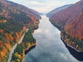 Autumnal landscape view of a mountain road and a lake Royalty Free Stock Photo