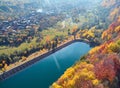 Autumnal landscape view of a mountain village and a lake