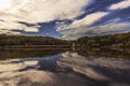 Wooden old windmills and their reflections on lake in Astra Museum Sibiu Romania in autumn.Beautiful landscape in Sibiu, Romania Royalty Free Stock Photo