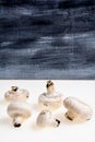 Autumnal Mushrooms with white background and gray wooden table Royalty Free Stock Photo