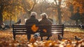 Autumnal park scene elderly couple sits on bench reading Royalty Free Stock Photo
