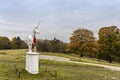 Autumnal parkland scene with modern sculpture.