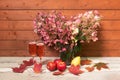 Autumnal pink hydrangea flowers, rose champagne and fresh fruits on aged wooden table Royalty Free Stock Photo