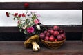 Autumnal red apples and huge mushroom and flowers on wooden bank