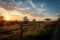 Autumnal sunset landscape with old orchard, wooden fence in foreground. Royalty Free Stock Photo