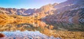 Autumnal Tatra mountains. Crystal water in the lake Big Pond surrounded by mountains in the Valley of Five Lakes. Poland. Royalty Free Stock Photo