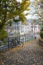 Autumnal trees and bicycle in border the Il river at the little france quarter